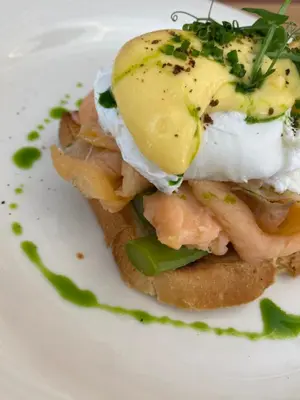 a sandwich with an egg on top on a white plate at Agkyra Hotel in Rhodes Town