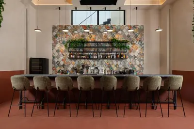 a bar in a room with chairs and a wall at Agkyra Hotel in Rhodes Town