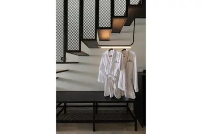 a coat hanging on a shelf under a staircase at Agkyra Hotel in Rhodes Town