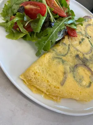 a omelet and a salad on a white plate at Agkyra Hotel in Rhodes Town