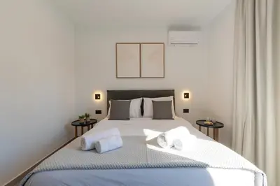 a bedroom with a large bed with towels on it at Rodos Downtown 107 in Rhodes Town
