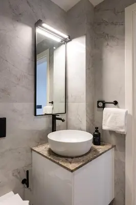 a bathroom with a white sink and a mirror at Rodos Downtown 107 in Rhodes Town