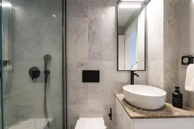 a bathroom with a sink and a shower at Rodos Downtown 107 in Rhodes Town