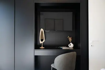 a mirror and a chair in a black room at Rodos Downtown 107 in Rhodes Town