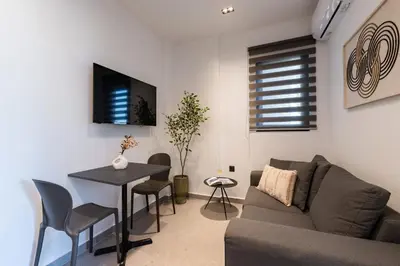 a living room with a couch and a table at Rodos Downtown 107 in Rhodes Town