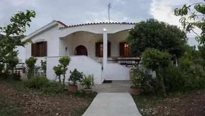 a white house with a pathway leading to it at Kolymbia home in Kolimbia