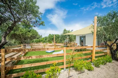 a wooden fence in front of a house at Arokaria Seaview House in Koskinou