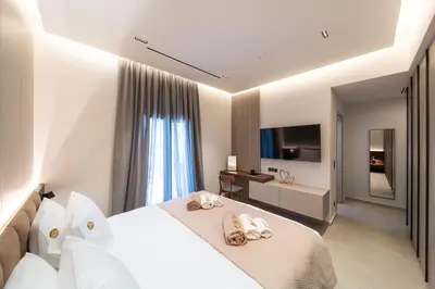 a hotel room with a bed with towels on it at Kyma Luxury Apartment in Rhodes Town
