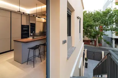 an open kitchen and dining area in a house at Kyma Luxury Apartment in Rhodes Town