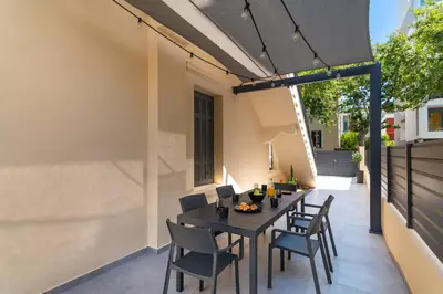 an outdoor dining area with a table and chairs at Kyma Luxury Apartment in Rhodes Town