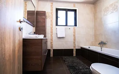 a bathroom with a sink and a tub and a toilet at Xristina Home in Afantou