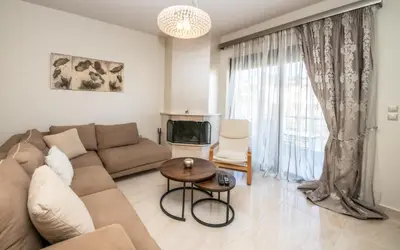 a living room with a couch and a table at Xristina Home in Afantou