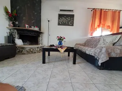 a living room with a couch and a table at Galinis Rooms in Paradeísion