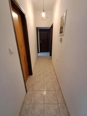 a hallway with a door and a tiled floor at Galinis Rooms in Paradeísion
