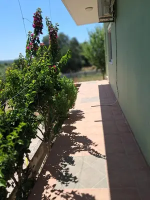 a walkway next to a building with flowers on it at Galinis Rooms in Paradeísion