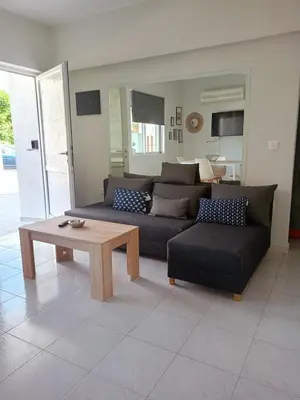 a living room with a couch and a coffee table at comfy cozy rodini in Asgourou