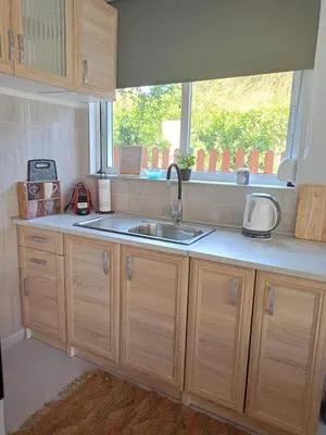 a kitchen with a sink and a window at comfy cozy rodini in Asgourou