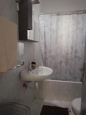 a bathroom with a sink and a shower curtain at comfy cozy rodini in Asgourou