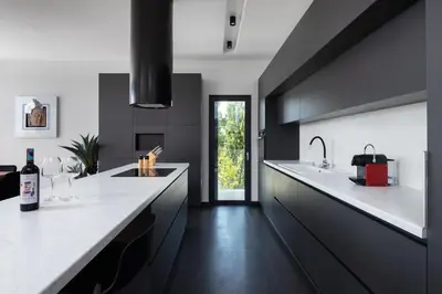 a kitchen with black cabinets and white counter tops at Sunset Villa Rhodes in Ixia