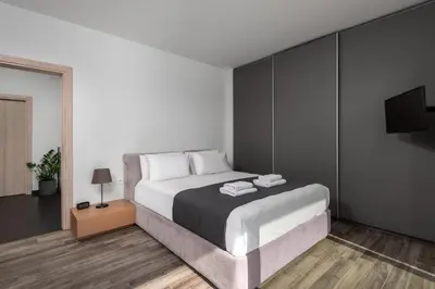 a bedroom with a large bed and a television at Sunset Villa Rhodes in Ixia