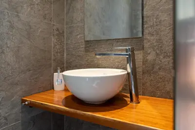 a bathroom with a bowl sink on a wooden counter at Sunset Villa Rhodes in Ixia