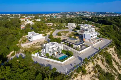 an aerial view of a large white house on a cliff at Sunset Villa Rhodes in Ixia