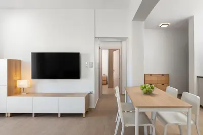 a dining room with a table and a tv on a wall at Irene Gem in Rhodes Town