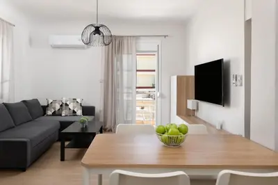 a living room with a table and a couch at Irene Gem in Rhodes Town