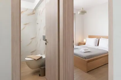 a small bedroom with a bed and a toilet at Irene Gem in Rhodes Town