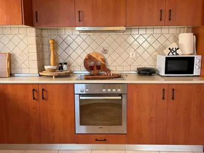 a kitchen with a stove and a microwave at Rodosia Apartment IN Rhodes in Rhodes Town