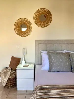 a bedroom with two mirrors on the wall and a bed at Rodosia Apartment IN Rhodes in Rhodes Town