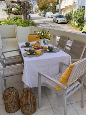 a white table and chairs on a patio at Rodosia Apartment IN Rhodes in Rhodes Town