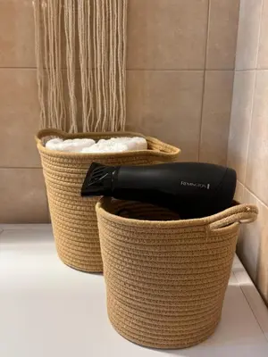 a black hair dryer in a basket in a bathroom at Rodosia Apartment IN Rhodes in Rhodes Town