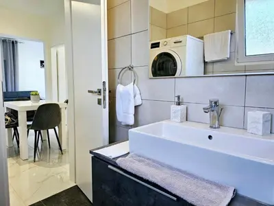 a white bathroom with a sink and a microwave at Dream Luxury Suites & Apartment Pastida in Pastida