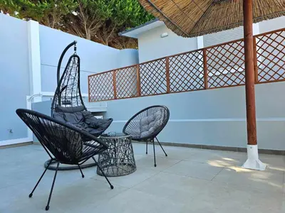 two chairs and a table on a patio at Dream Luxury Suites & Apartment Pastida in Pastida