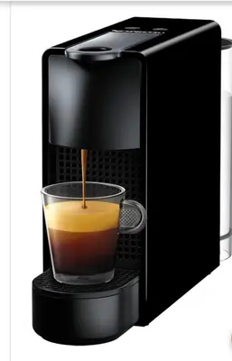 a coffee maker with a cup of coffee at House Marigo Suites in Koskinou