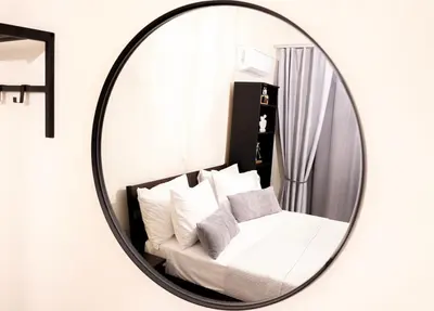 a mirror in a living room with a couch at Serenity Escape in Nísos Ródos