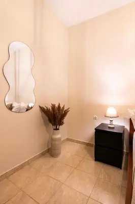 a room with a lamp and a plant on the wall at Serenity Escape in Nísos Ródos