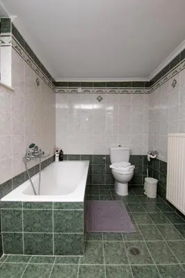 a bathroom with a bath tub and a toilet at Serenity Escape in Nísos Ródos