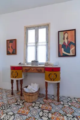 a room with a table and two chairs and a window at Peaceful Lindos in Líndos