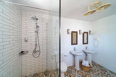 a bathroom with two sinks and a shower at Peaceful Lindos in Líndos