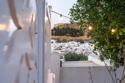 a view of a city from the balcony of a house at Peaceful Lindos in Líndos