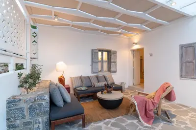 a living room with a couch and a table at Peaceful Lindos in Líndos