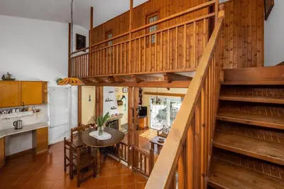 a kitchen with wooden stairs and a table in a kitchen at Yannis Place in Rhodes Town