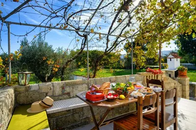 a table with food on it on a patio at Yannis Place in Rhodes Town
