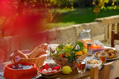 a picnic table with bread and baskets of food at Yannis Place in Rhodes Town