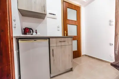 a kitchen with a sink and a dishwasher at Hotel Dimitra Sun in Archangelos