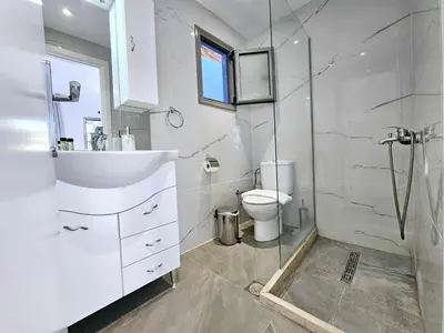 a bathroom with a toilet and a sink and a shower at Dream Luxury Apartment Suites in Pastida