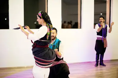 a group of people standing around a woman on a dance floor at Cyprotel Faliraki in Faliraki