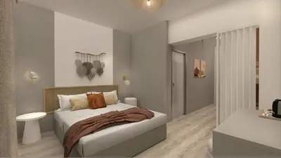 a white bedroom with a bed and a bathroom at Cyprotel Faliraki in Faliraki